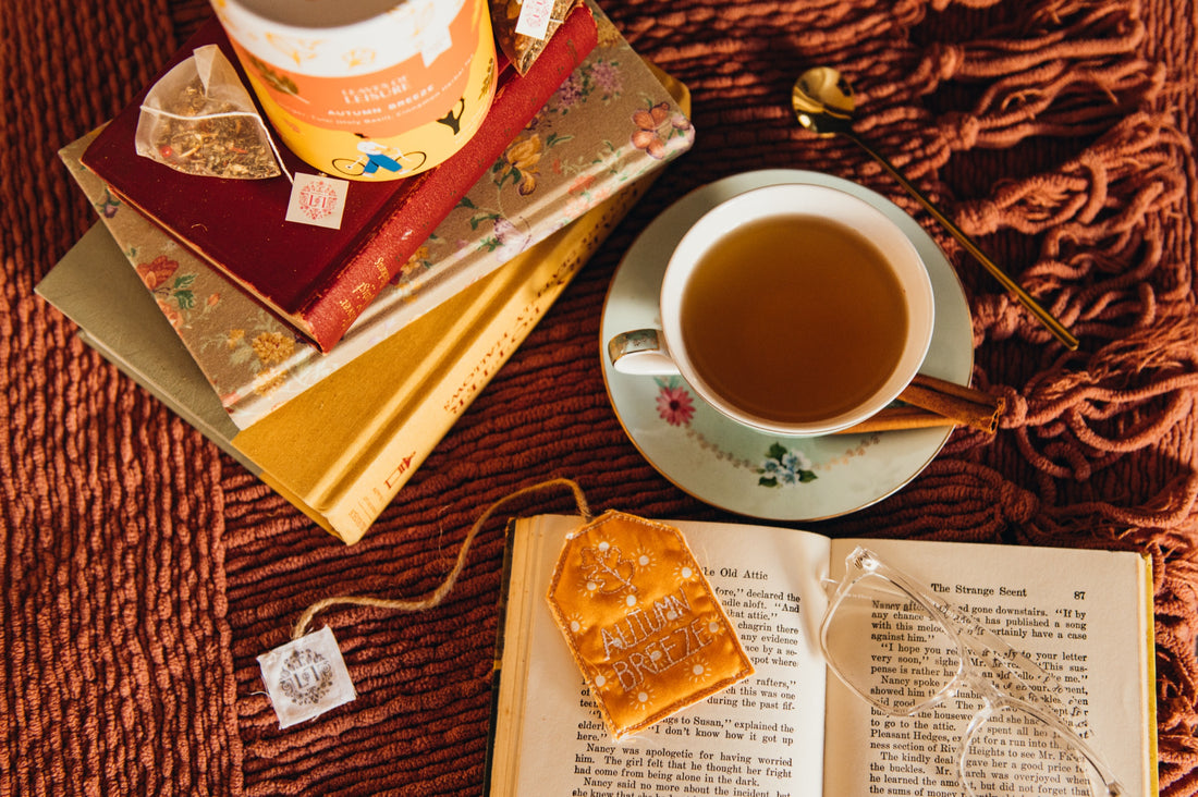 Autumn Breeze herbal tea with a cup of tea and a stack of books